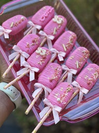 pink frosted popsicles on a tray