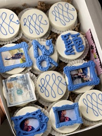 a box of cupcakes with pictures on them